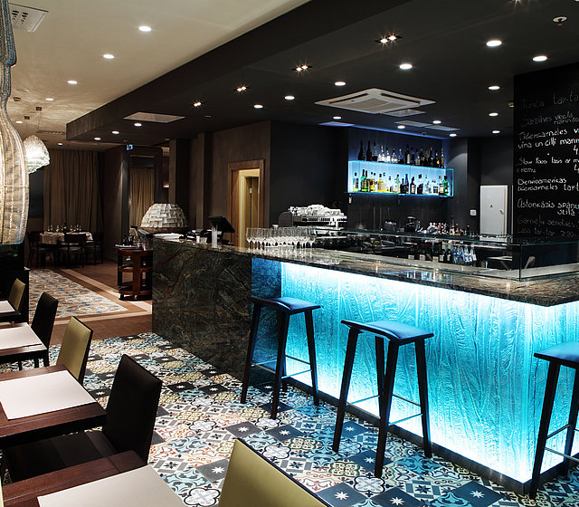 Blue-lit hotel bar at Gastronome Riga Restaurant